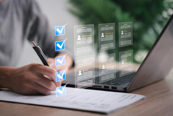 Person writing on paper with projected images of information and checkboxes.